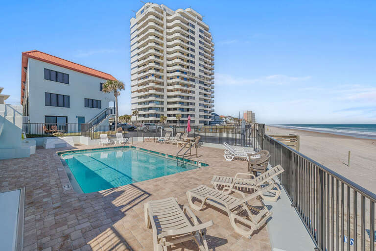 Unwind at the oceanfront pool with direct beach access and panoramic Atlantic views. Lounge poolside, soak up the Florida sunshine, and enjoy a relaxing beach stay just steps from the sand and surf.