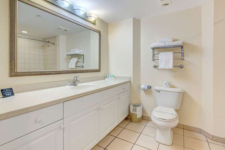 Bright Bathroom With Broad Mirror, Beige Tiles