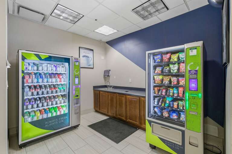Vending Machines With Snacks And Drinks In A Tiled Room