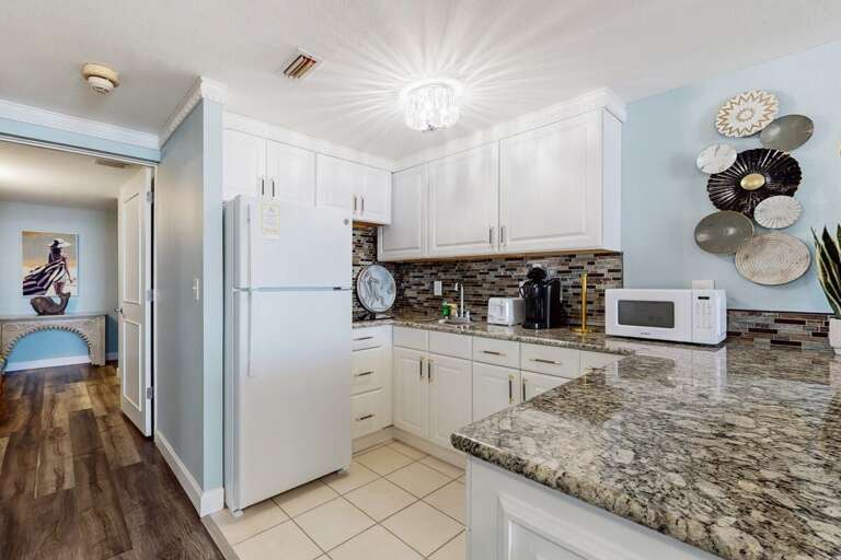 Bright Blue Kitchen With White Cabinets And Granite Countertops