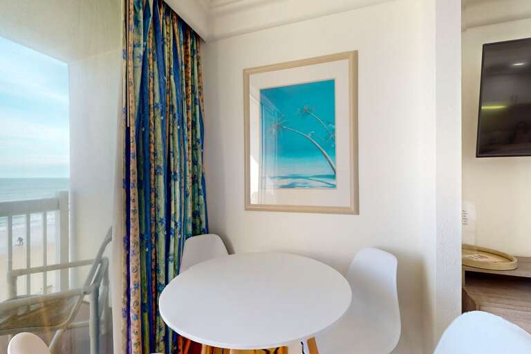 Round Table With Chairs, Ocean View Balcony, Beach Artwork