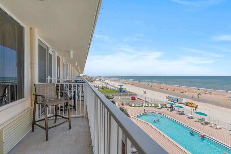 Take in breathtaking oceanfront views from your private balcony overlooking the sparkling pool and