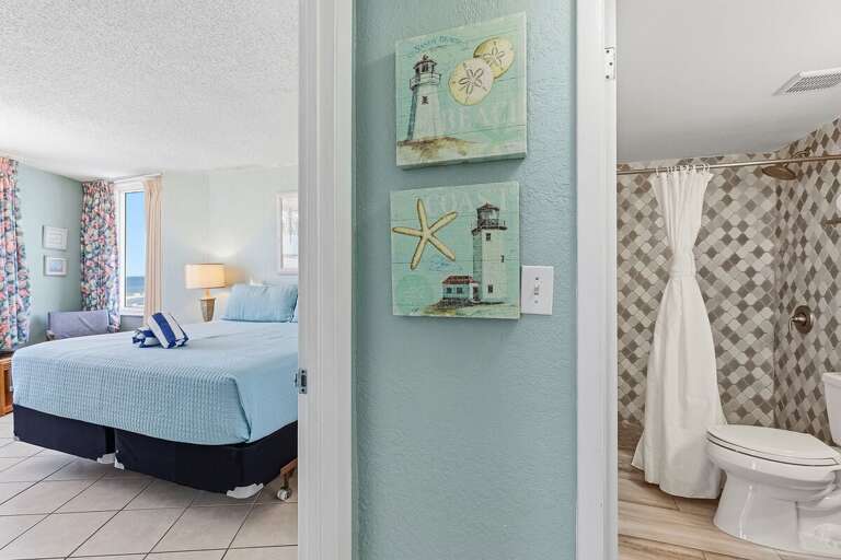 Enjoy the comfort of a spacious king bedroom with coastal décor, easy access to a private ensuite