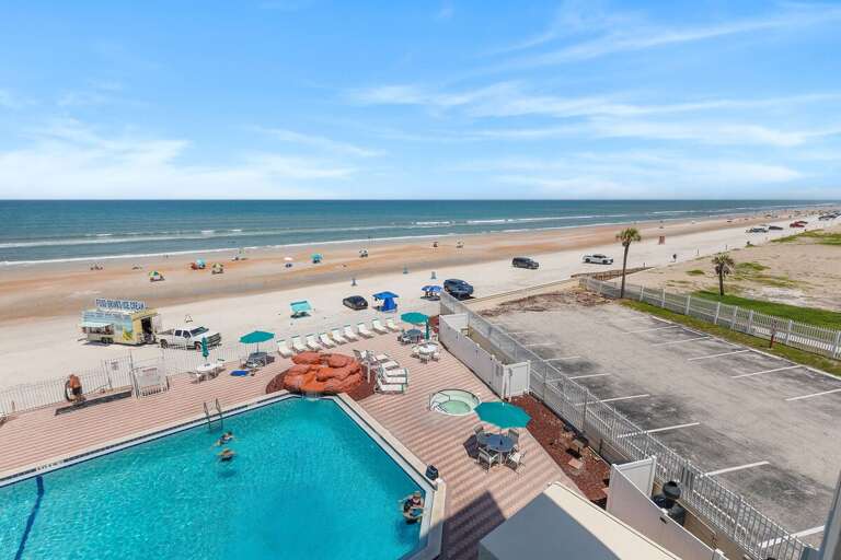 Experience the ultimate beach stay with a sparkling oceanfront pool, relaxing hot tub, and direct