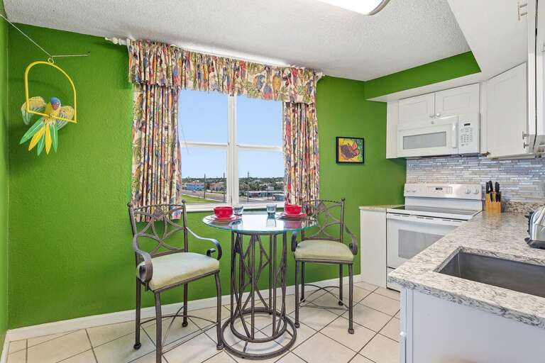 Start your day in this bright coastal kitchen featuring modern finishes, full-size appliances, and a