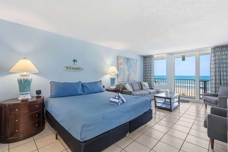 Unwind in this spacious oceanfront studio featuring a king bed, cozy sitting area, and private