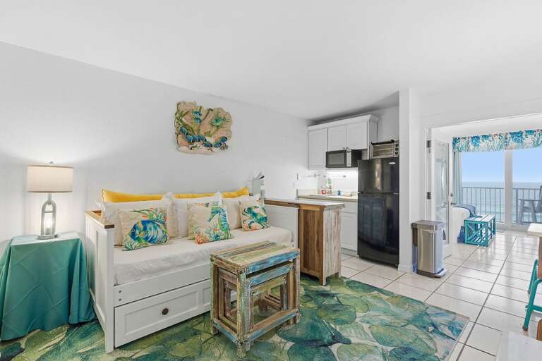 Seaside Studio Space With Sleeping Setup, Small Kitchen, And Balcony Access