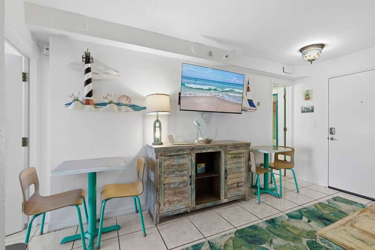 Beach-themed Living Space With Striped Furnishings And Sea-inspired Decor In A Vacation Rental