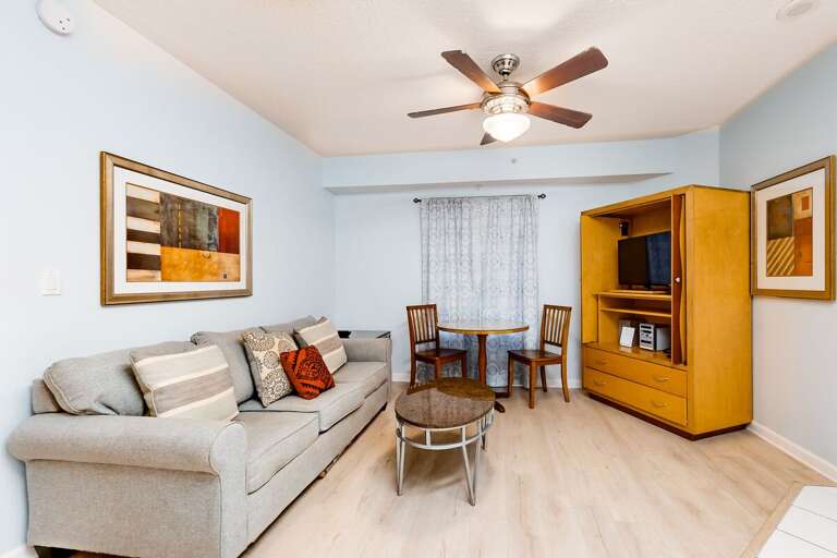Bright and inviting living space featuring comfy seating, dining nook, and entertainment center—perfect for unwinding after a fun-filled beach stay. Enjoy a relaxed, coastal vibe throughout.