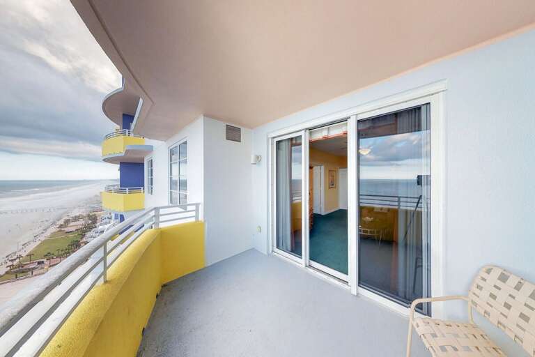 Spacious beach stay balcony with sweeping ocean views, perfect for morning coffee or sunset unwinding. Enjoy the fresh sea breeze just steps from your coastal getaway living room.