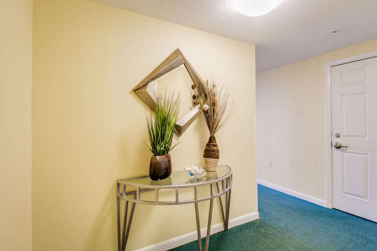 Stylish beach-inspired entryway featuring modern décor, coastal greenery, and warm lighting—a welcoming start to your relaxing beach stay.