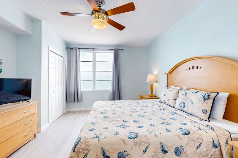 Wake up to stunning ocean views in this coastal-themed bedroom. Soft blue tones, beachy décor, and a comfy king bed create the perfect retreat for your relaxing beach stay.
