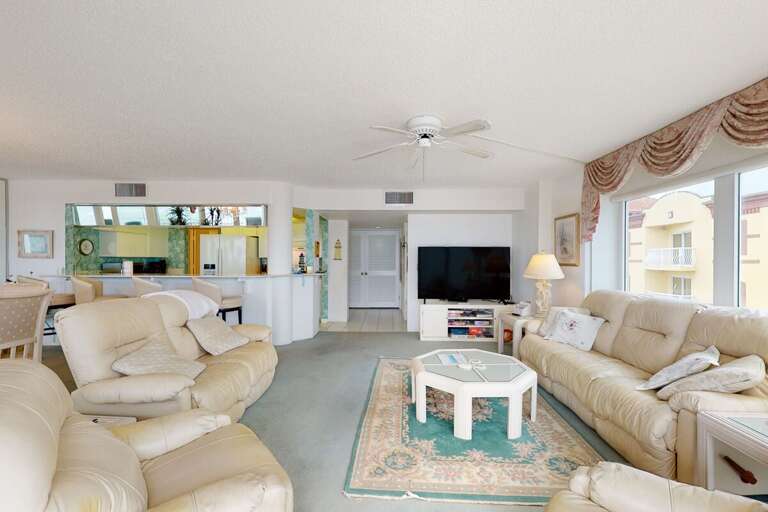 Enjoy a roomy coastal living space with plush seating, bright natural light, and easy access to your beach stay amenities—perfect for unwinding after a day by the ocean.