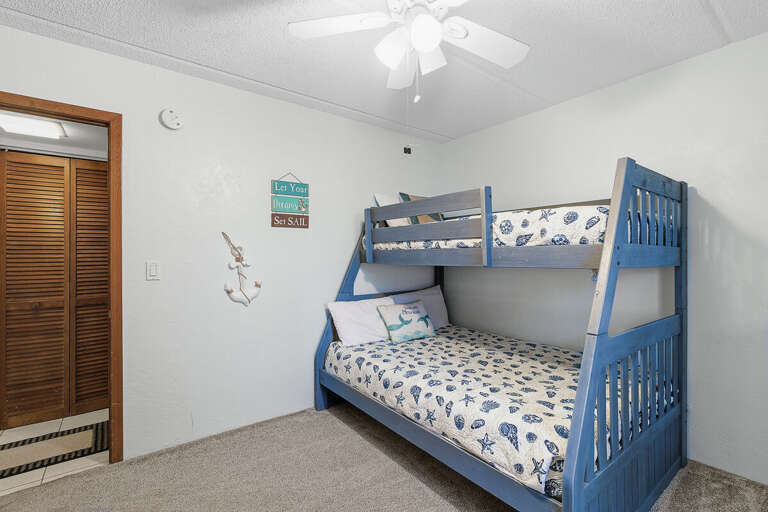 This charming bunk room is perfect for your beach stay, featuring cozy beds and nautical décor.