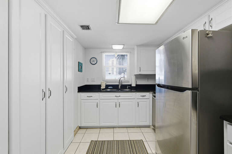 Enjoy a convenient beach stay with this clean, well-equipped kitchen featuring stainless steel