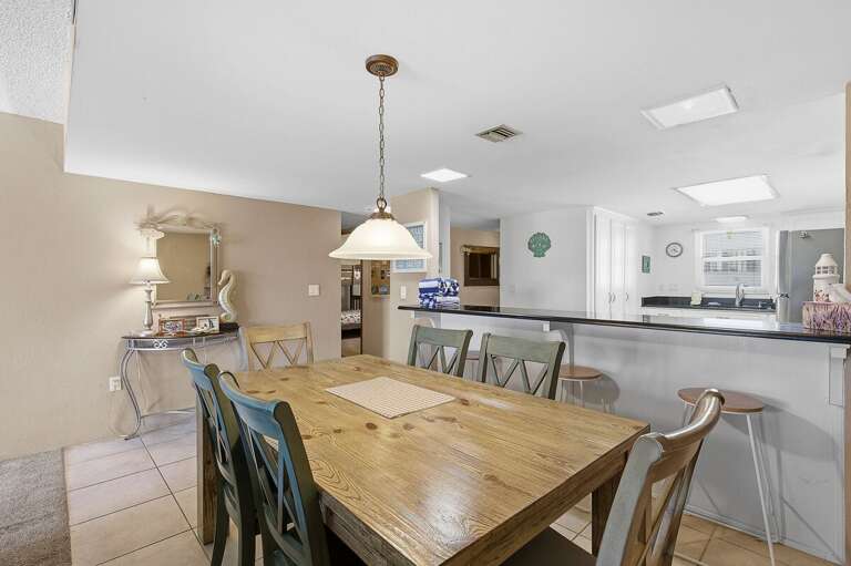 Enjoy meals together during your beach stay in this warm dining area with seating for six and a