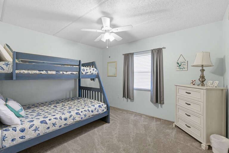 Ideal for your beach stay, this cozy bunk room offers comfortable sleeping for kids or groups with coastal décor and a relaxed vibe. A great space to unwind after a fun-filled day at the beach.
