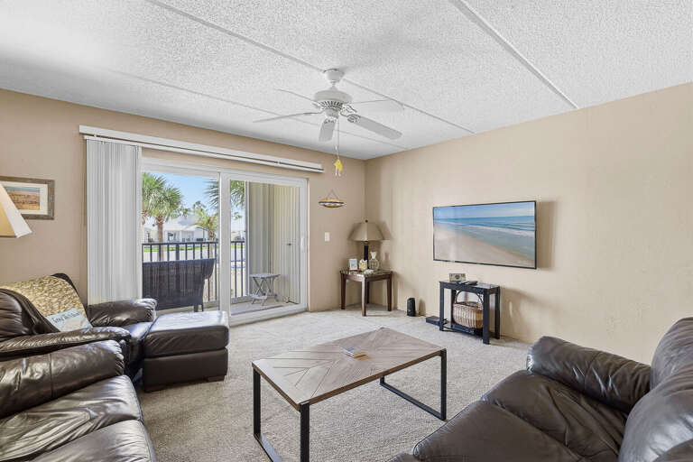 Kick back and relax during your beach stay in this bright living room with comfortable seating and a