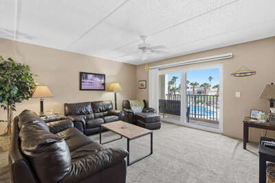 Relax in this spacious beach stay featuring cozy seating, natural light, and a private balcony
