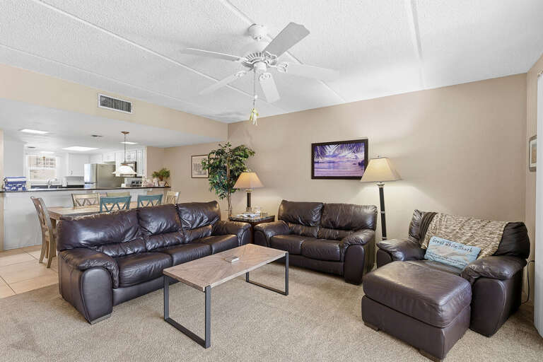 Relax during your beach stay in this inviting living room with plush seating and an open layout