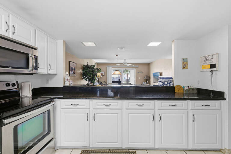 This spacious kitchen features ample counter space, modern appliances, and a convenient breakfast