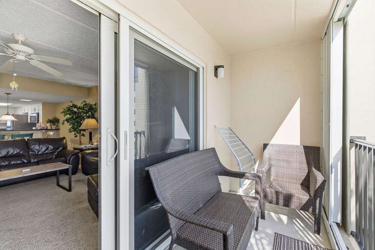 Step outside and relax during your beach stay on this private balcony with comfortable seating. Enjoy fresh coastal air and a peaceful spot to unwind after a day at the beach.