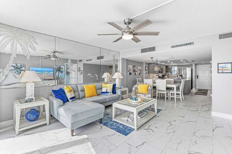 Enjoy an open-concept beachfront retreat featuring a stylish living room, dining area, and modern