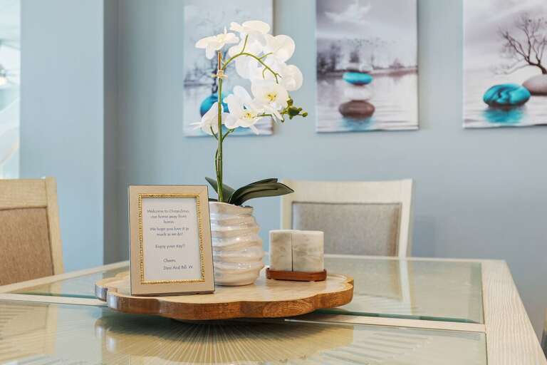 Gather around this beautifully styled dining table featuring coastal décor and a welcoming