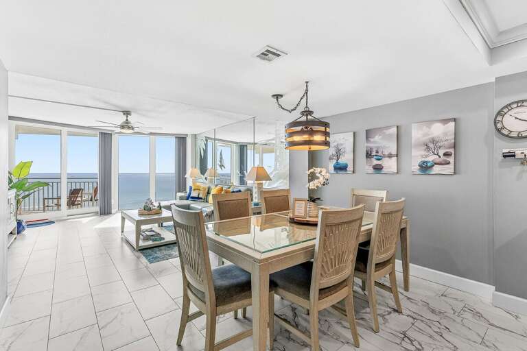 Gather for meals in this bright oceanfront dining area with seating for six, an open-concept layout,