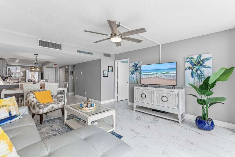 Kick back after a day at the beach in this bright coastal living room featuring a Smart TV,