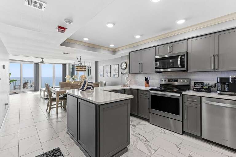 Prepare meals in this modern oceanfront kitchen featuring stainless steel appliances, a spacious