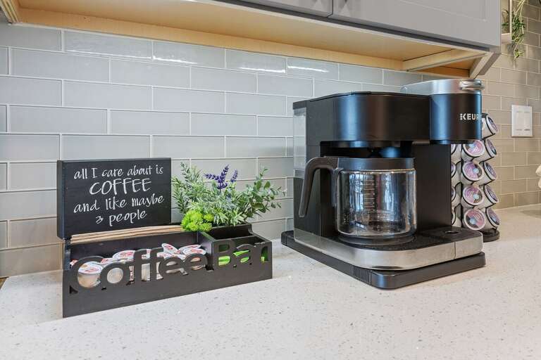 Start your beach stay with a fresh cup from the convenient coffee station featuring a Keurig, drip coffee maker, and complimentary coffee pods. The perfect way to fuel up before a day at the beach.