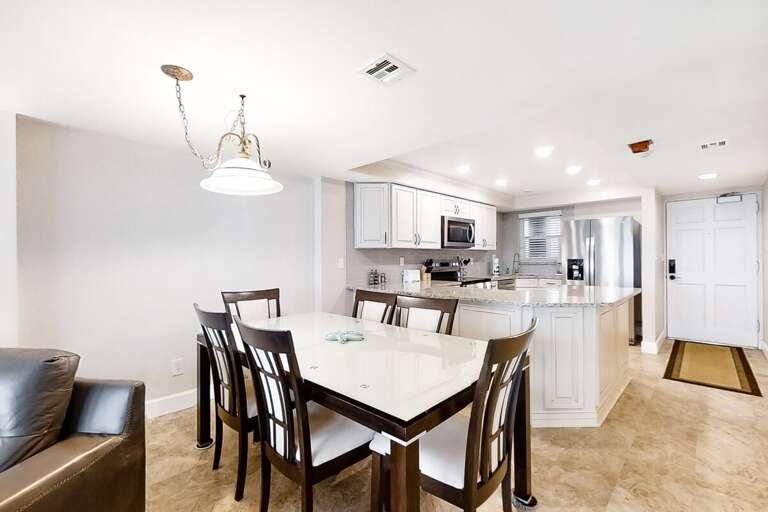 Spacious Dining Setup Leading To Sleek Kitchen Space