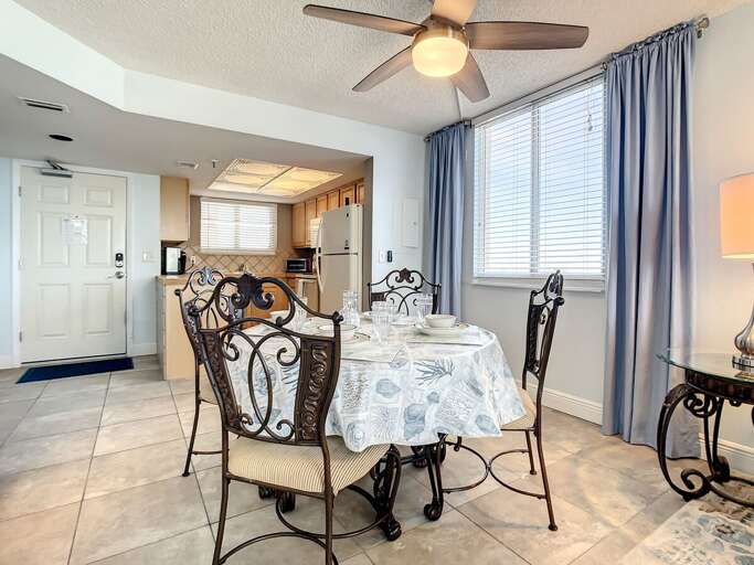 Elegant dining setup near large windows, offering a bright and welcoming space for meals and gatherings.