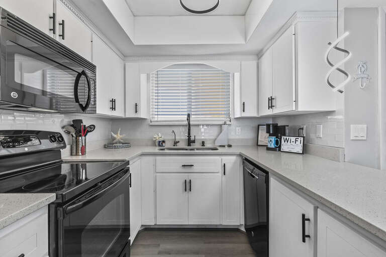 With ample counter space and a functional layout, this kitchen is both practical and elegant, ideal for meal prep and casual dining.