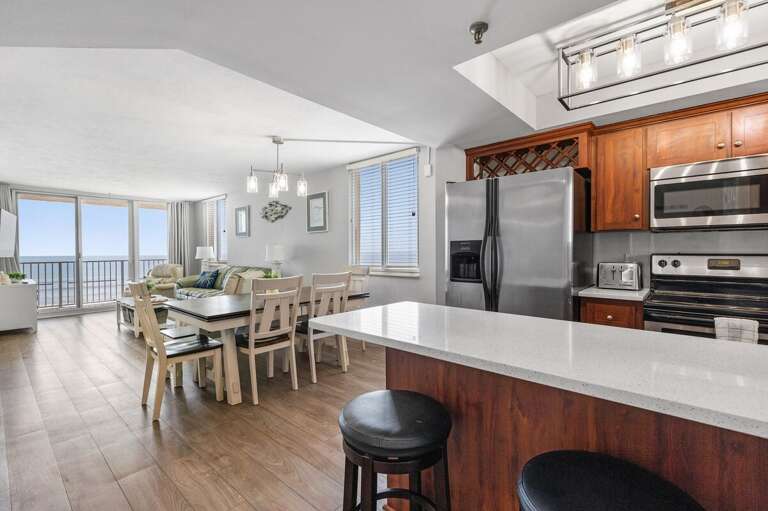 Bright, airy design connecting the kitchen, dining, and living area with oceanfront views.