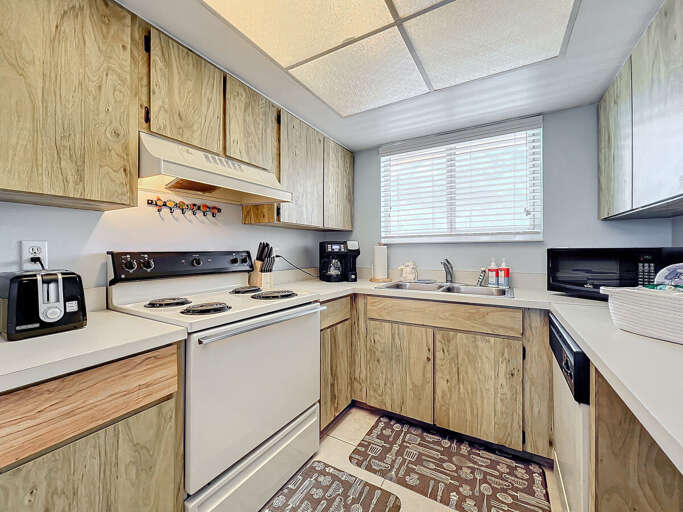 Cook with ease in this inviting kitchen, featuring essential appliances, natural light, and a functional layout perfect for preparing meals during your stay.