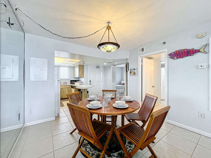 Dine in style in this inviting area featuring wooden chairs, vibrant décor, and convenient access to the kitchen and living spaces for seamless entertaining.