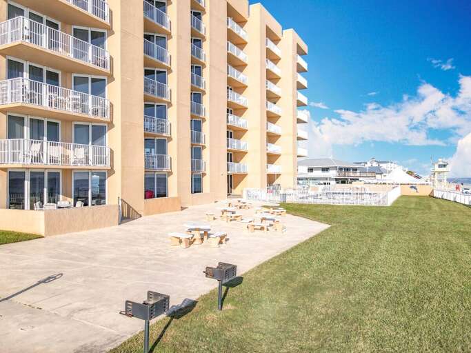 Enjoy outdoor barbecues or relax in this spacious area featuring grills, picnic tables, and stunning oceanfront views, perfect for memorable seaside gatherings.