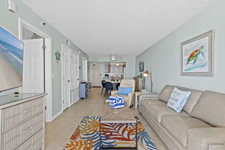 Bright, beach-themed living space with cozy seating, ocean-inspired decor, and relaxing vibes.