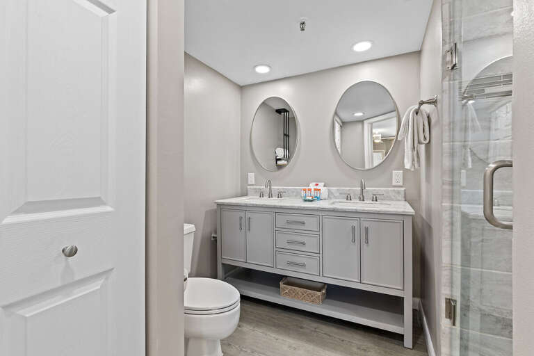 Enjoy a sleek bathroom with dual sinks, stylish mirrors, and ample space for your needs.