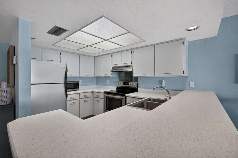 Prepare meals with ease in this bright, spacious kitchen featuring ample counter space, full-size