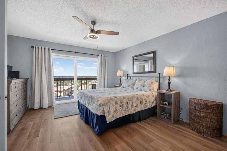 Relax in this bright coastal bedroom featuring beach-inspired décor, comfortable furnishings, and direct access to a private balcony. A peaceful retreat to start and end each day of your beach stay.