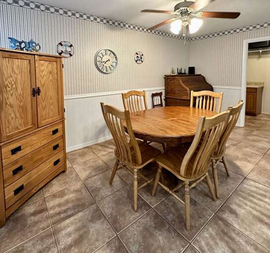 Charming dining area with a classic wooden table and seating for six, perfect for shared meals or game nights.