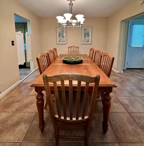 Elegant dining room with a large wooden table and seating for eight, perfect for group dinners or