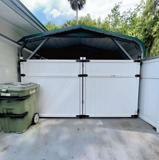 Private gated carport with secure double-door entry — great for safely parking your car, storing beach gear, or keeping outdoor equipment tucked away during your stay!