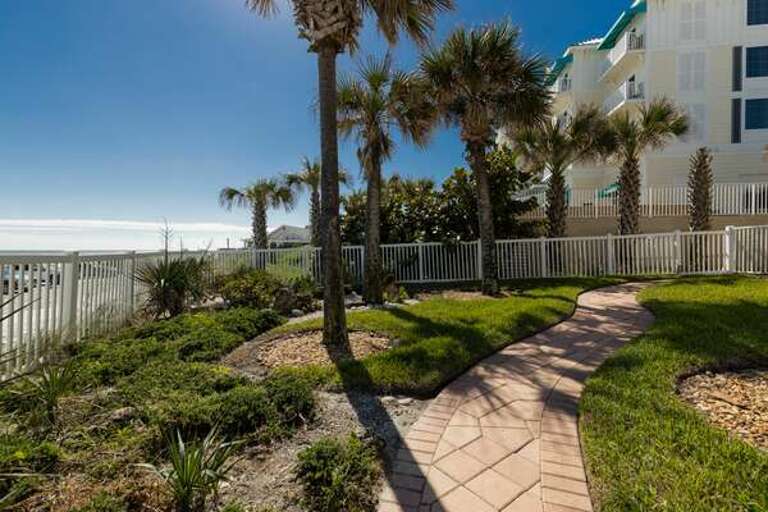Stroll along this scenic, palm-lined pathway with ocean views, leading you closer to the sand and surf. Perfect for a morning walk or a sunset beachside escape during your coastal getaway.