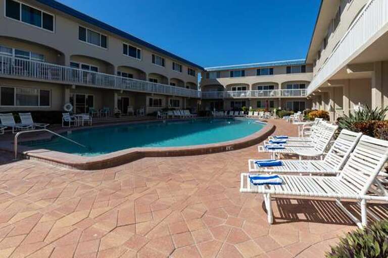 Unwind by the sparkling pool just steps from the sand. Perfect for lounging after a beach day, with plenty of seating to soak up the sun and enjoy your coastal getaway.