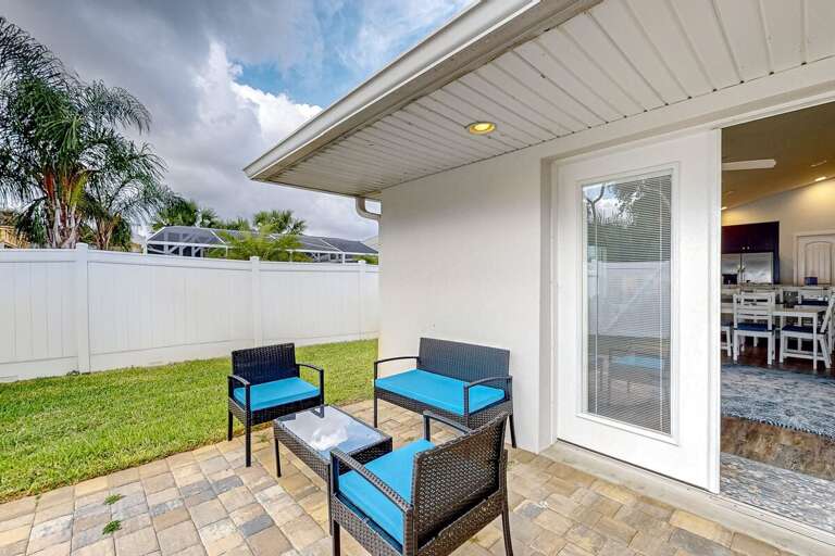 Relax on the beach-inspired patio with comfy outdoor seating and fenced privacy—perfect for morning coffee or unwinding after a fun day by the shore.