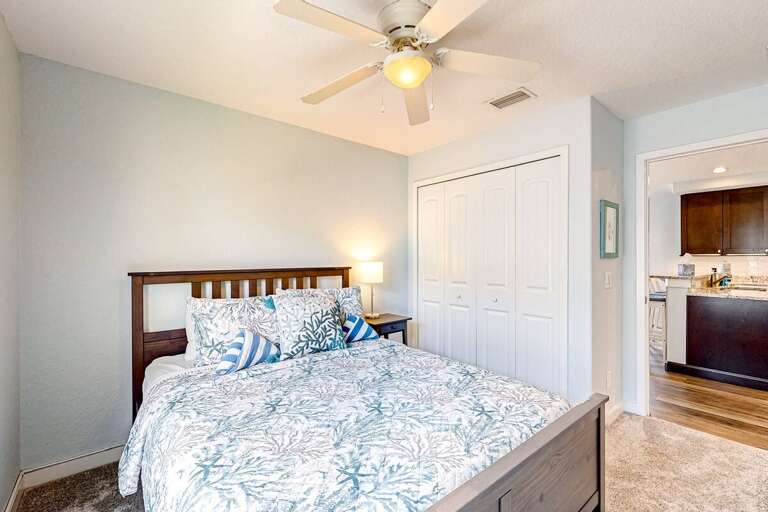 Rest easy in this bright beach-inspired bedroom featuring soft coastal décor, plush bedding, and easy access to the main living areas—perfect for unwinding after a sun-soaked beach stay.